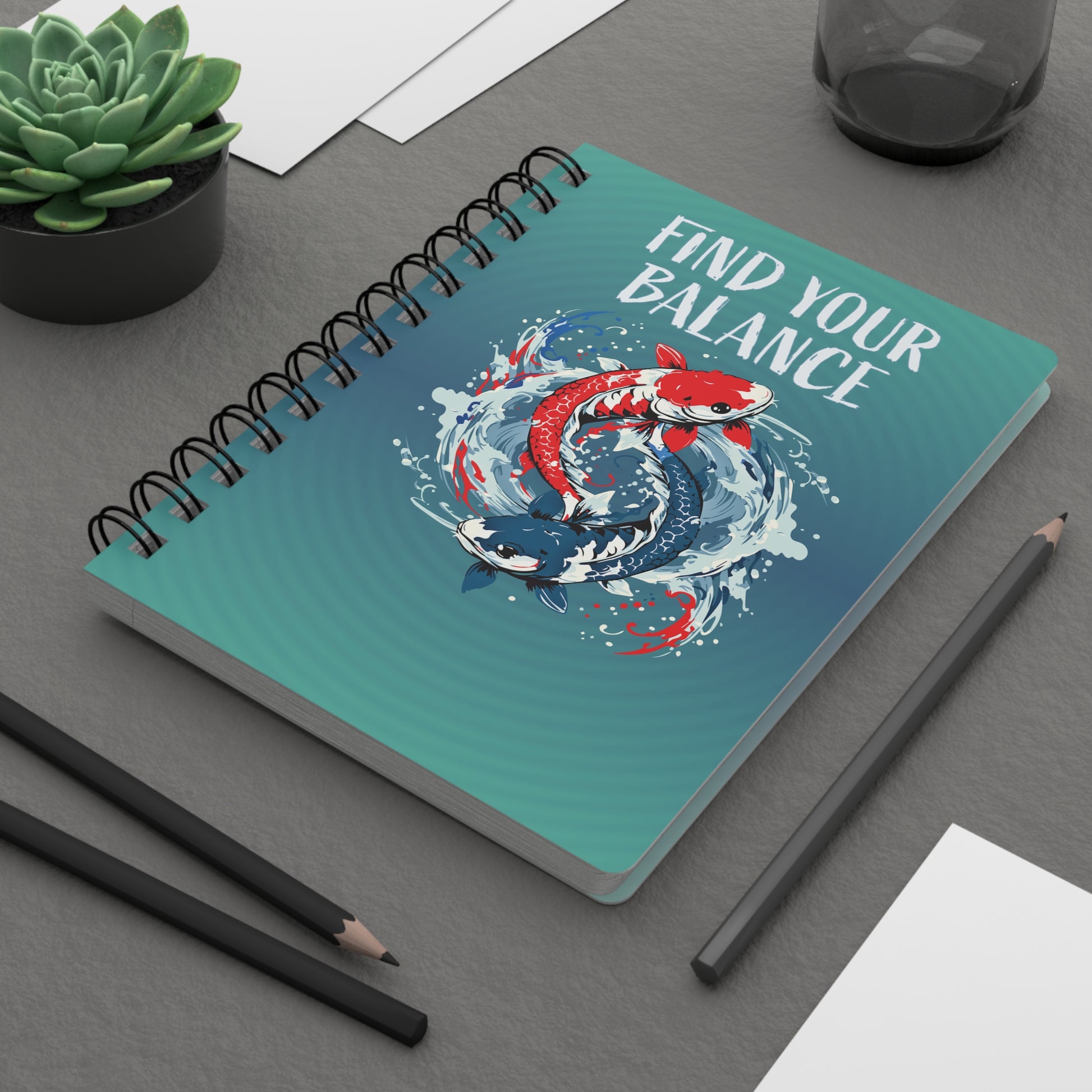 A wire bound journal with a glossy laminate finish. The diary features two koi fish in a yin yang pattern splashing out of the water